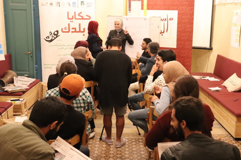 A group seated in a circle during a storytelling workshop